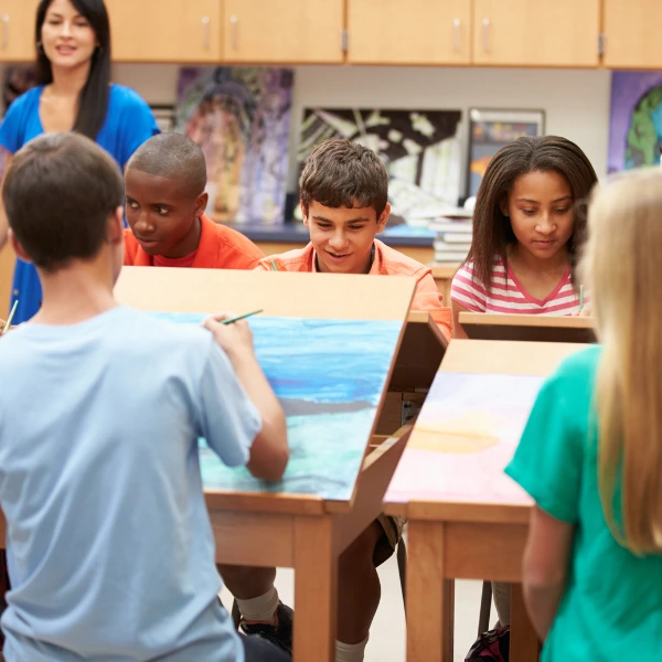 Students painting in a classroom.